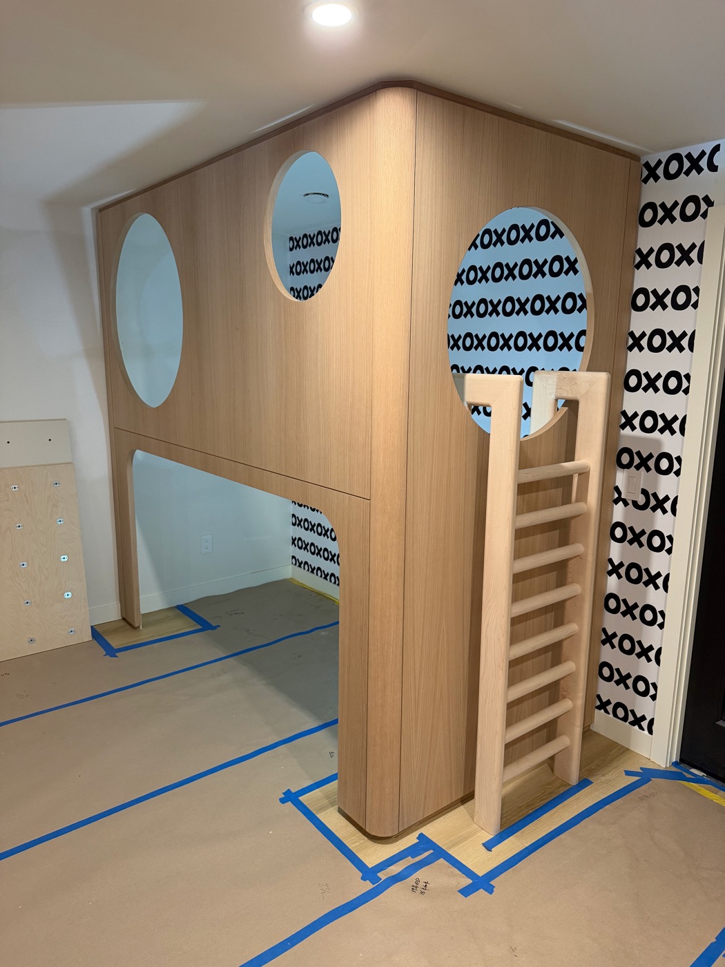 Built-in oak loft bed with round window