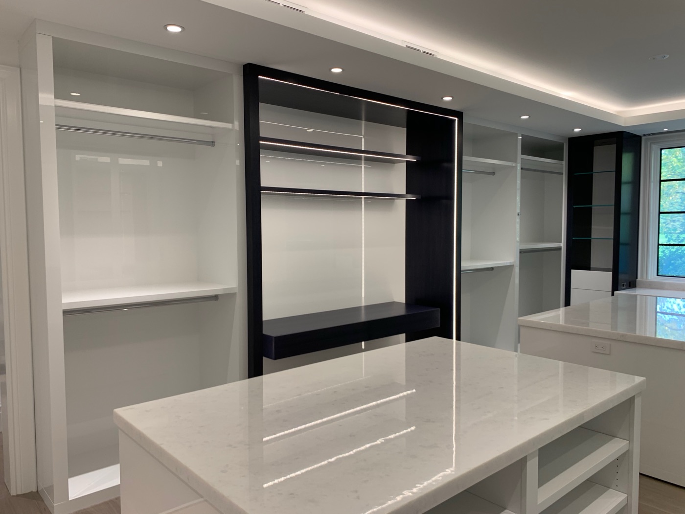 Luxury walk-in closet with marble island