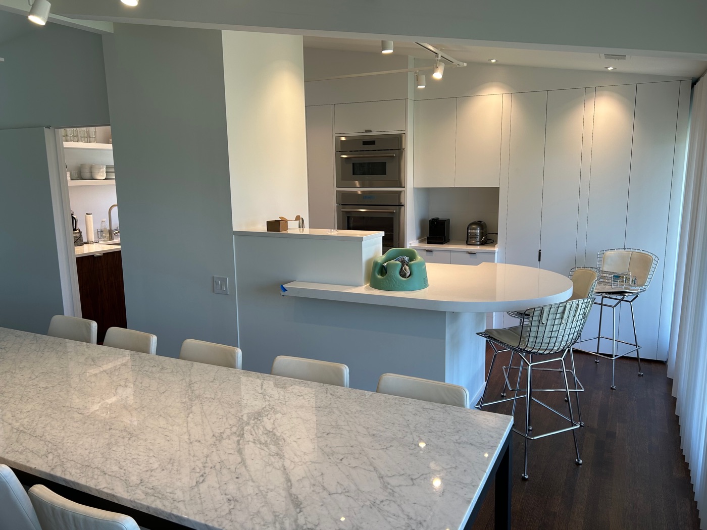 White kitchen, wide view with dining area