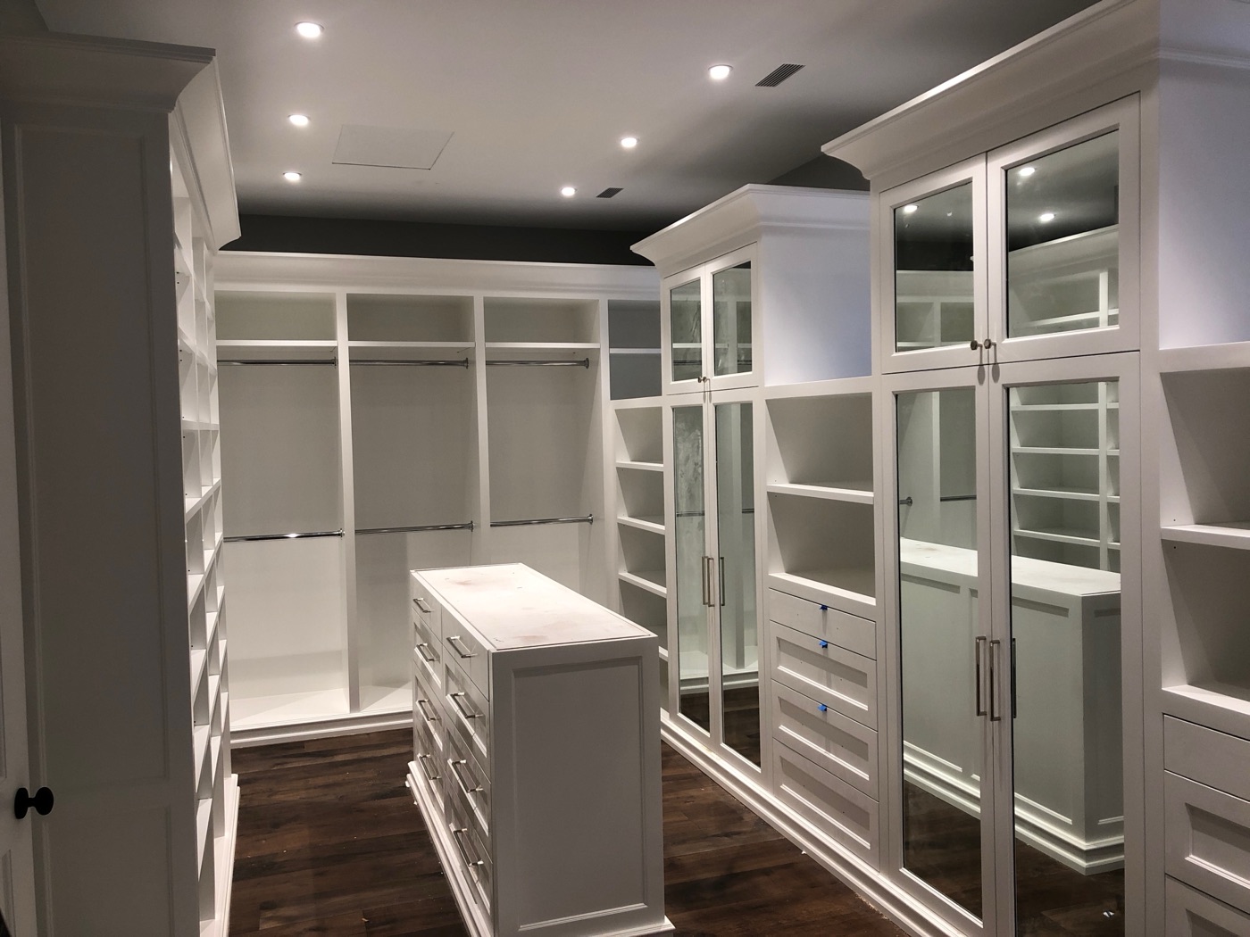 Walk-in closet with glass cabinet doors