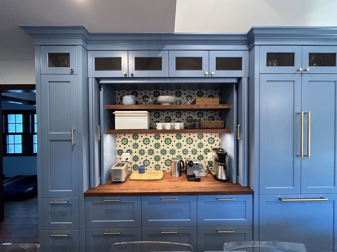 Mudroom built-ins with doors open, revealing coffee station with tiled backsplash