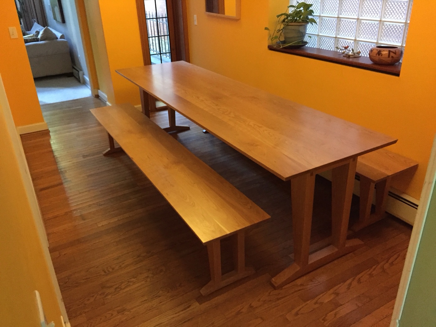 Cherry trestle table and benches in a client's dining room